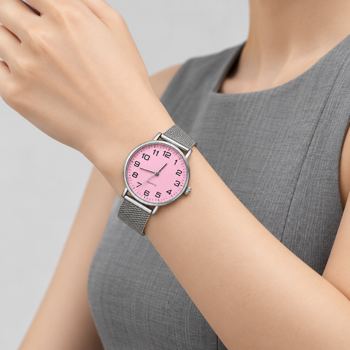 Pink dial silver mesh watch - wrist closeup